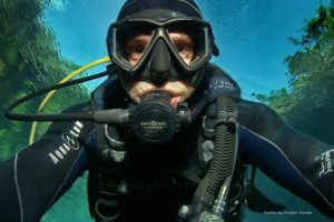 Closeup of Andre Fedak under water, scuba diving.