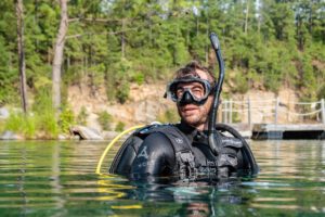Photo of Brandon Harris in scuba gear in a lake.